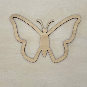 May include: A wooden butterfly cutout, perfect for crafting projects. The butterfly is a simple silhouette with no details.