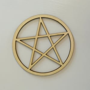 May include: A wooden pentagram, or five-pointed star, is cut out of a circular piece of wood.