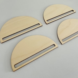 May include: Four unfinished wooden half-circle shapes with a cut-out slot in the center. The shapes are arranged in a staggered pattern.