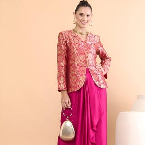 May include: A fuchsia draped skirt and matching jacket with gold brocade detailing. The outfit is completed with a gold clutch and strappy heels. The ensemble is suitable for formal events.