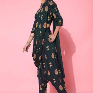 May include: A dark green printed crop top and matching dhoti pants with a floral design. The outfit is made of a soft, flowing fabric and has a relaxed fit.