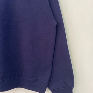 May include: A navy blue sweatshirt with the logo "Cardone Contracting" embroidered on the front in white and red.