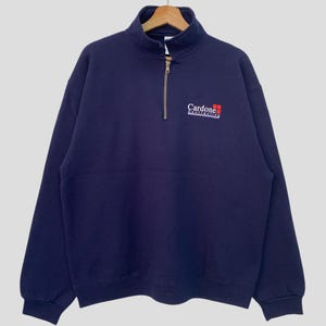 May include: A navy blue quarter-zip sweatshirt with the logo "Cardone Contracting" embroidered on the front.