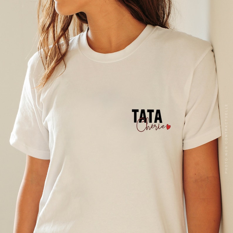 May include: White t-shirt with black text that says "TATA Ch&eacute;rie" with a red heart.