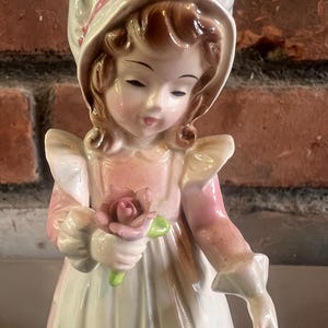 Vintage Josef Originals figurine, specifically from their &quot;Flower Girl&quot; series or a similar line featuring girls holding flowers.