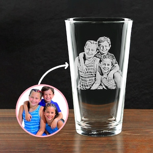 May include: A clear pint glass with a photo of three children etched on the front. The children are smiling and hugging each other. A smaller, circular photo of the children is in the lower left corner.