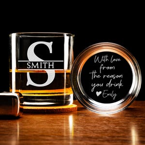 May include: A personalized glass whiskey tumbler with the initial "S" and the name "SMITH" etched on the front. The coaster has the text "With love from the reason you drink Emily" etched on it.
