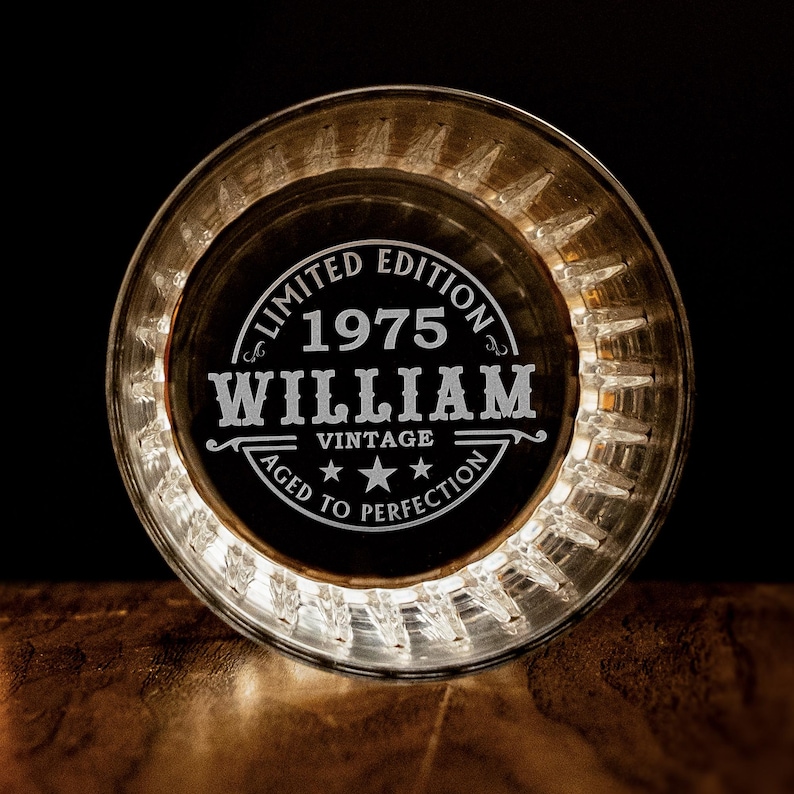 May include: A clear glass coaster with a white engraved design that reads "Limited Edition 1975 William Vintage Aged to Perfection".