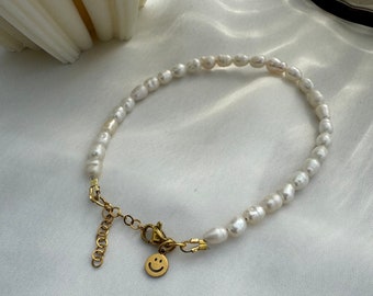 Bracelet or anklet made of small freshwater pearls with a smiley pendant