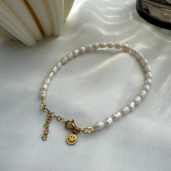 Bracelet or anklet made of small freshwater pearls with a smiley pendant