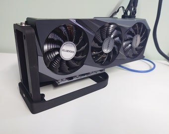 May include: A black graphics card with three fans. The fans have the Gigabyte logo on them. The card is mounted in a black metal bracket.