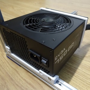 May include: A black computer power supply unit with a fan and a power cord. The unit is labeled "EVGA 750 GR".
