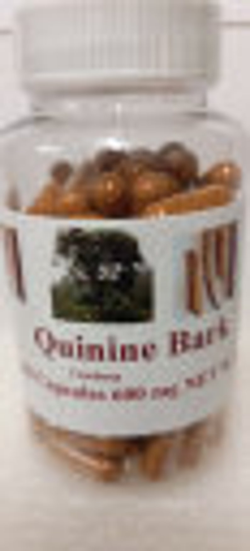 May include: A clear plastic bottle filled with brown capsules. The bottle has a white label with the text "Quinine Bark" and a picture of a tree.