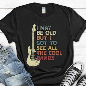 May include: Black t-shirt with a vintage-style graphic of an electric guitar and the text "I may be old but I got to see all the cool bands".