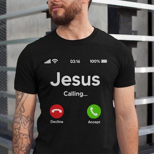 May include: Black t-shirt with a white phone screen graphic that says "Jesus Calling..." with a green "Accept" button and a red "Decline" button.
