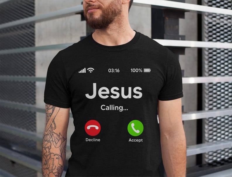 May include: Black t-shirt with a white phone screen graphic that says "Jesus Calling..." with a green "Accept" button and a red "Decline" button.
