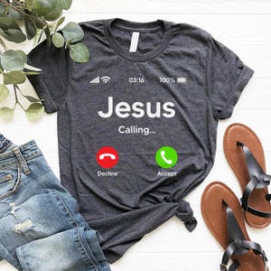 May include: A dark gray t-shirt with the text "Jesus Calling..." and a phone icon with two buttons: "Decline" and "Accept".