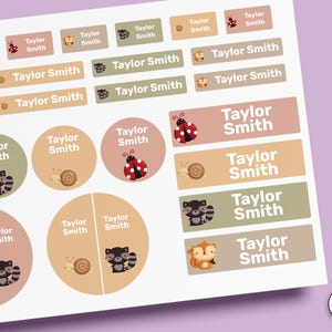 May include: A sheet of adhesive labels in various shapes and sizes featuring the name Taylor Smith. The stickers include illustrations of ladybirds, snails, raccoons, and squirrels in muted earth tones. The text STICK-ON is visible on the side.