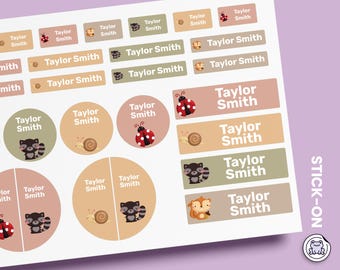 May include: A sheet of adhesive labels in various shapes and sizes featuring the name Taylor Smith. The stickers include illustrations of ladybugs, snails, raccoons, and squirrels in muted earth tones. The text STICK-ON is visible on the side.