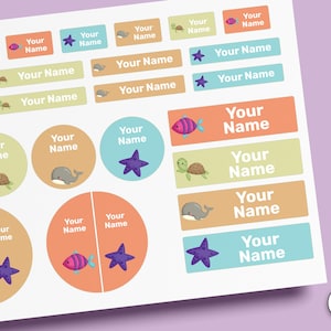 May include: A sheet of adhesive labels featuring various sea creatures including turtles, whales, starfish, and fish in pastel colors. Each label includes the placeholder text Your Name. The sheet includes rectangular and circular stickers.