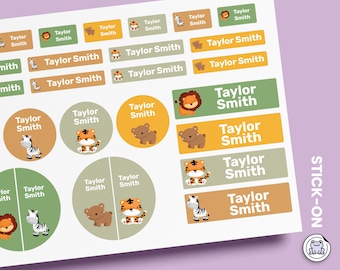 May include: A sheet of rectangular and circular adhesive labels in shades of green, tan, and orange. Each label features the name Taylor Smith in white text alongside illustrations of a lion, tiger, zebra, or bear. The text STICK-ON is visible.