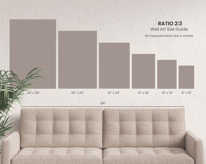 May include: A wall art size guide with a 2:3 ratio, displaying various rectangular canvas sizes in inches. Sizes range from 8" x 12" to 24" x 36". The text "RATIO 2:3 Wall Art Size Guide" is displayed. A beige sofa is in the foreground.
