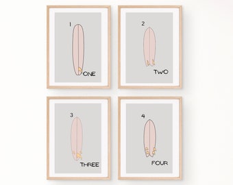 May include: Set of four framed prints featuring illustrations of pink surfboards with yellow fins. Each print has a number and the word "ONE", "TWO", "THREE", or "FOUR" written below the surfboard.
