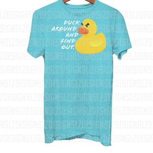 May include: A turquoise blue t-shirt with a yellow rubber duck and the text "Duck around and find out."