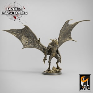 May include: A gold-colored miniature figurine of a winged creature with a reptilian head and a humanoid body. The creature has large, detailed wings and is standing on a small, rocky base.