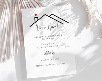 May include: A white invitation card with the text "We're Home!" and a house graphic with a red heart. The card includes details for a housewarming celebration, including the date, time, and hosts' names. The bottom right corner has the text "Effy Creative."