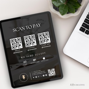 May include: A digital tablet displays a payment screen with the text "SCAN TO PAY." It features QR codes for Zelle, Venmo, and Cash App, along with payment options. The tablet is next to a laptop and a small plant.