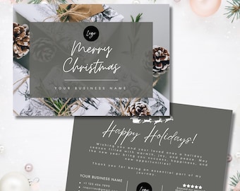 May include: A gray and white Christmas card with a pine cone and a wrapped gift on the front. The card reads "Merry Christmas" and "Your Business Name". The back of the card has a message wishing happy holidays and a new year filled with success and happiness. It also includes contact information for the business and a QR code.