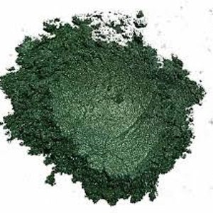 May include: A close-up of a pile of dark green mica powder. The powder has a shimmery, metallic finish.