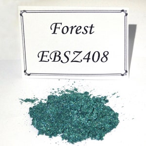 May include: A small pile of green glitter pigment with a white label that reads "Forest EBSZ408".