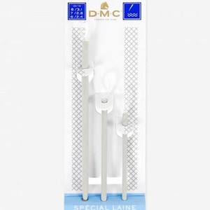 May include: A set of three silver knitting needles with round ends. The needles are labeled "Special Laine, Special Wool, Especial Lana" and "3 Aiguilles, Needles, Agujas".