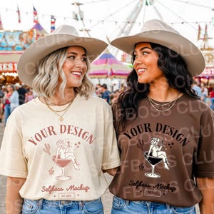 May include: Two women wearing beige and brown t-shirts with a graphic design of a woman in a martini glass. The shirts have the text "YOUR DESIGN" and "Selfboss Mockup" on them. Both women are wearing cowboy hats.