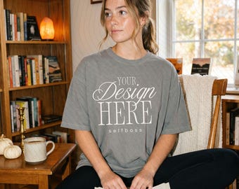 May include: A grey short-sleeved t-shirt featuring the white text "YOUR Design HERE" in a mix of script and serif fonts, with the word "selfboss" printed in smaller sans-serif letters underneath the main text on the front of the garment.