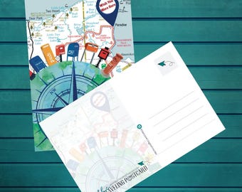 May include: Two postcards with a map design. One shows a map with a compass, mailboxes, and the text "Wish You Were Here." The other postcard has lines for writing and the text "thetravelingpostcard.com."