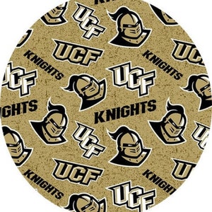 May include: A gold and black fabric with a repeating pattern of the University of Central Florida logo, which includes the letters UCF, the word "Knights", and a knight's helmet.