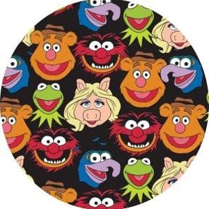 May include: A black background with a repeating pattern of colorful cartoon character faces, including Kermit the Frog, Miss Piggy, Animal, Fozzie Bear, Gonzo, and Scooter.
