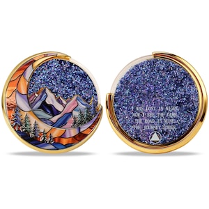 May include: Two-sided, gold-rimmed coin with a stained-glass mountain and moon design. The other side has glitter and text that reads "WAS LOST IN NIGHT, NOW I SEE THE DAWN, THE ROAD IS MINE, THE JOURNEY SOBER."