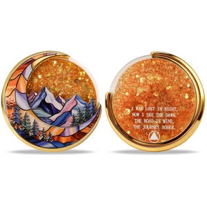 May include: Two-sided, gold-rimmed coin with a moon-shaped design. One side features a stained-glass mountain scene with trees. The other side has text: "I WAS LOST IN NIGHT, NOW I SEE THE DAWN. THE ROAD IS MINE, THE JOURNEY SOBER."