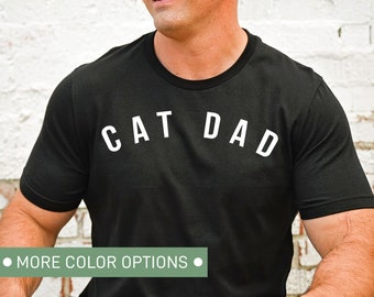May include: Black t-shirt with white text that reads "CAT DAD".