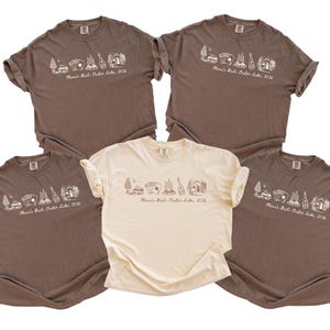 five brown t-shirts with a similar design, arranged in a row.