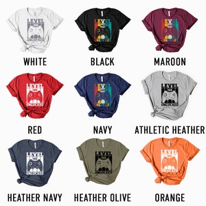 May include: A set of ten t-shirts in various colors, each featuring a retro-style video game controller graphic with the text "Level 40 Unlocked".