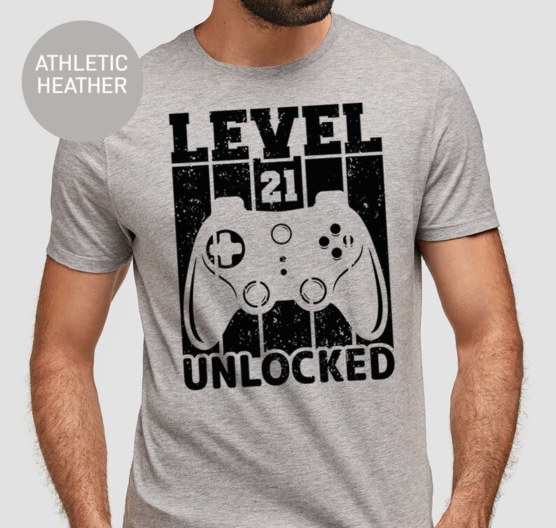 May include: A gray t-shirt with a black graphic of a video game controller and the text "LEVEL 21 UNLOCKED".