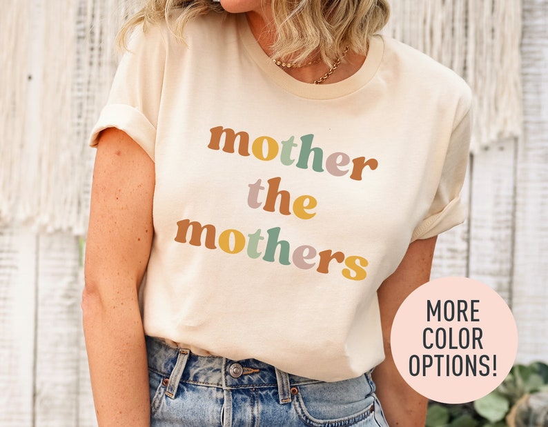 a woman wearing a t - shirt that says mother the mothers