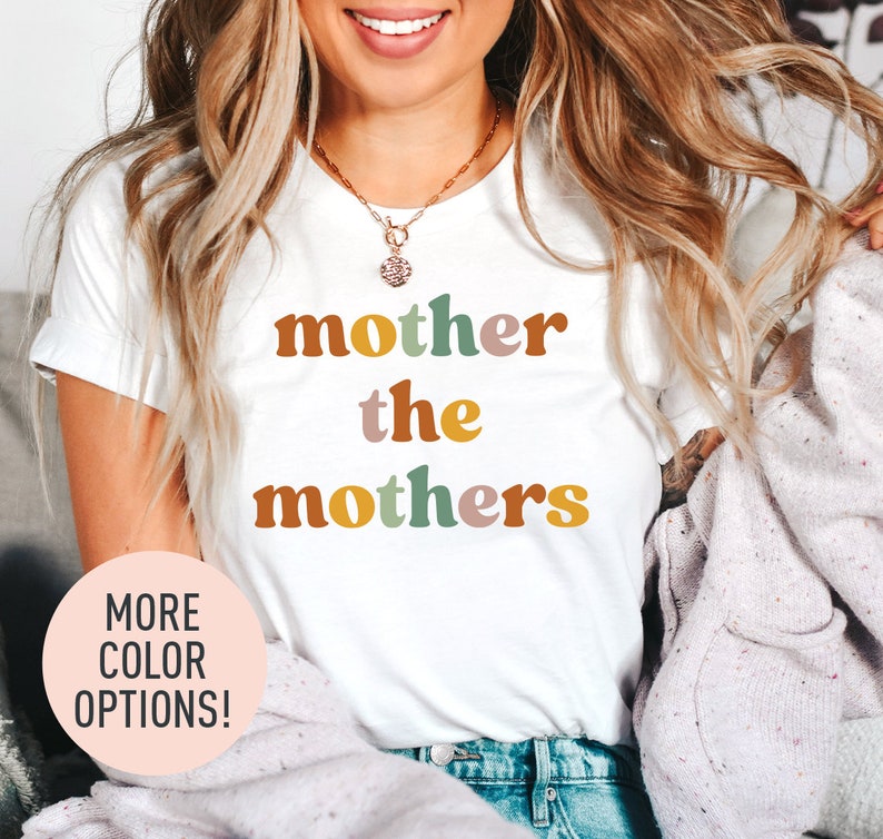 a woman wearing a t - shirt that says mother the mothers