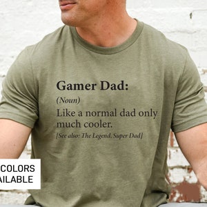 May include: A green t-shirt with the text "Gamer Dad: (Noun) Like a normal dad only much cooler. [See also: The Legend, Super Dad]" printed on the front.