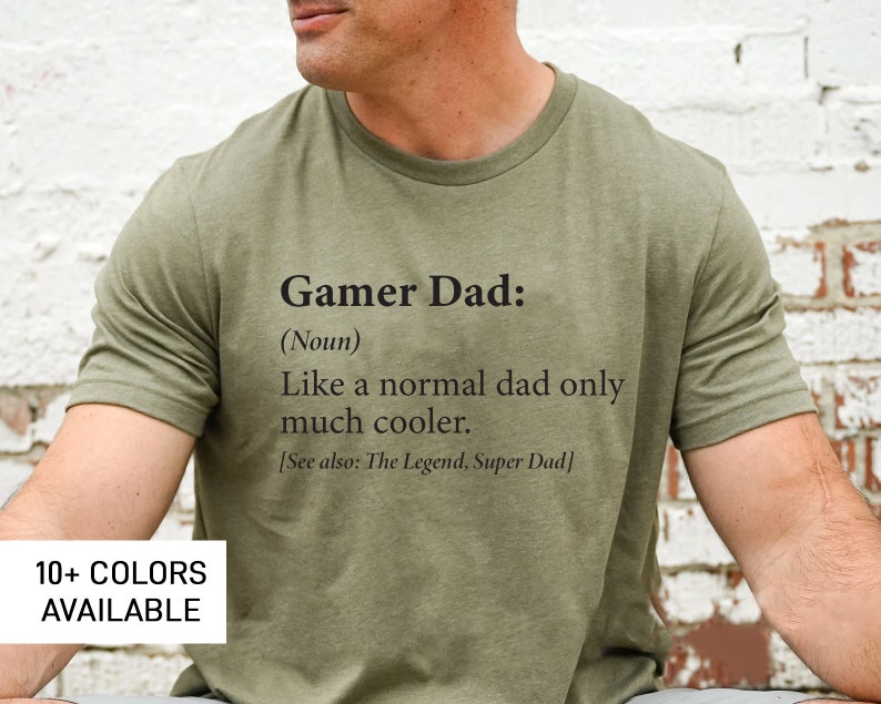 May include: A green t-shirt with the text "Gamer Dad: (Noun) Like a normal dad only much cooler. [See also: The Legend, Super Dad]" printed on the front.